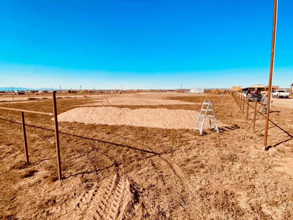 Pipe and Cable Fencing for a Riding Arena, sand footing is being brought in during construction by Integrity Welding Service LLC, servicing the Front Range of Colorado.