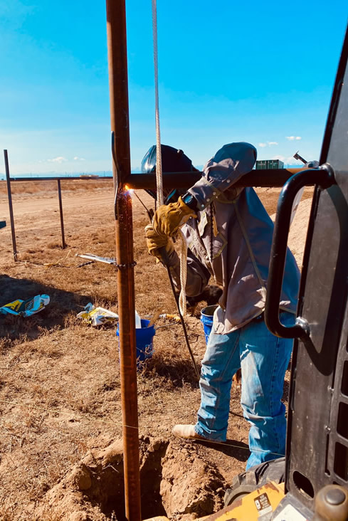 Pipe and Cable Fencing for a Riding Arena, tying in gates for the cattle working box on the north side of the arena. Construction by Integrity Welding Service LLC, servicing the Front Range of Colorado.