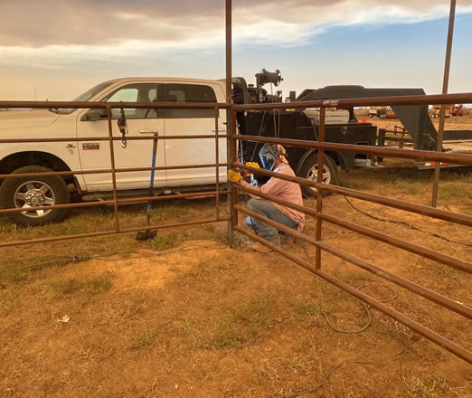 Pipe and Cable Fencing for a Riding Arena, tying in gates for the cattle working box on the north side of the arena. Construction by Integrity Welding Service LLC, servicing the Front Range of Colorado.