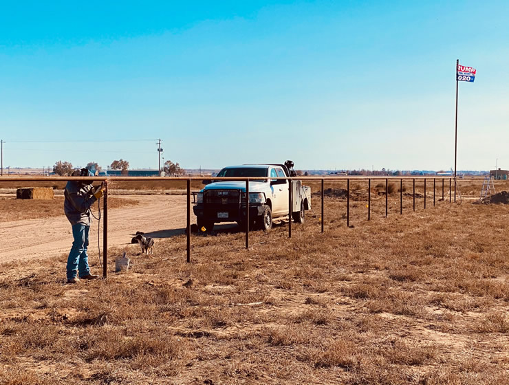 Pipe and Cable Fencing for a Riding Arena construction placing the toprail by Integrity Welding Service LLC, servicing the Front Range of Colorado.