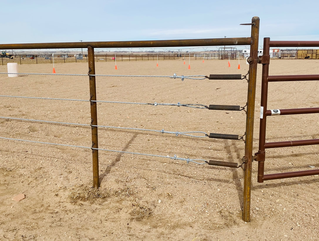 Pipe and Cable Fencing for a Riding Arena, with 4 Strands of Galvanized cable. With a Continous Fence Tie Rail, built using fence springs to keep the cable tension tight. Construction by Integrity Welding Service LLC, servicing the Front Range of Colorado.