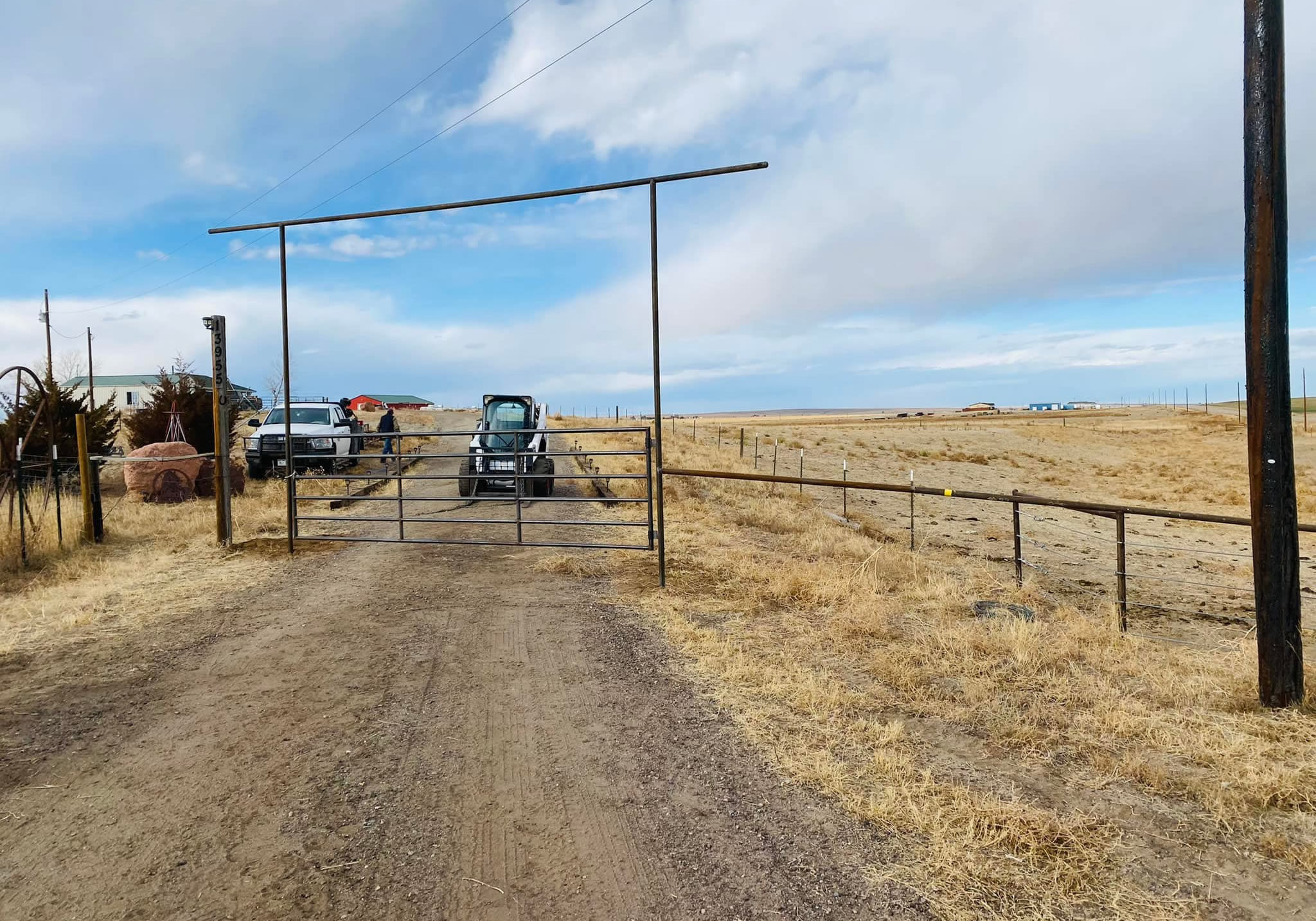 Pipe and Cable Fencing tied into a Custom Entrance Drill Stem Pipe Rustic Overhang complete with Weld on Gate. Constructed by Integrity Welding Service LLC, servicing the Front Range of Colorado.