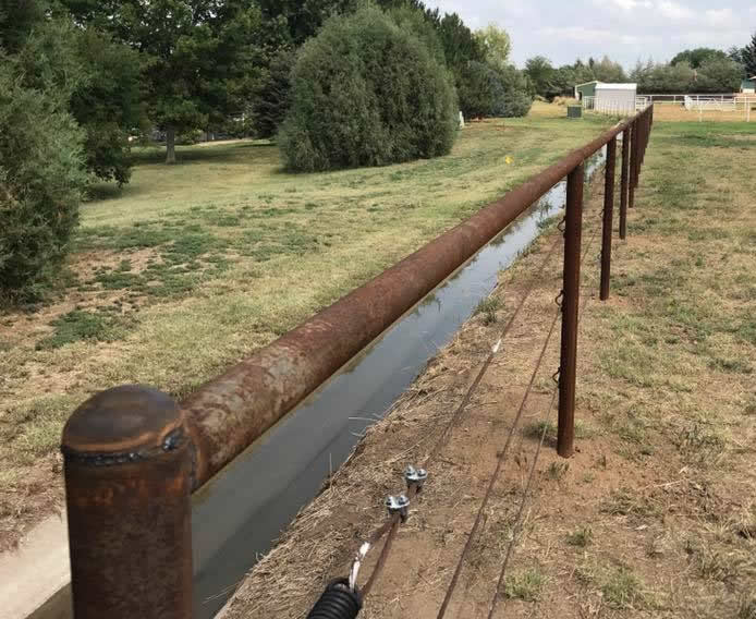 Pipe and Cable Fencing, with 3 Strands of Cable easy to mow around great next to ditches. Constructed by Integrity Welding Service LLC, servicing the Front Range of Colorado.