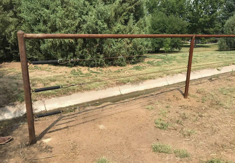 Pipe and Cable Fencing, with 3 Strands of Cable for a Property Perimeter Fence. Constructed by Integrity Welding Service LLC, servicing the Front Range of Colorado.