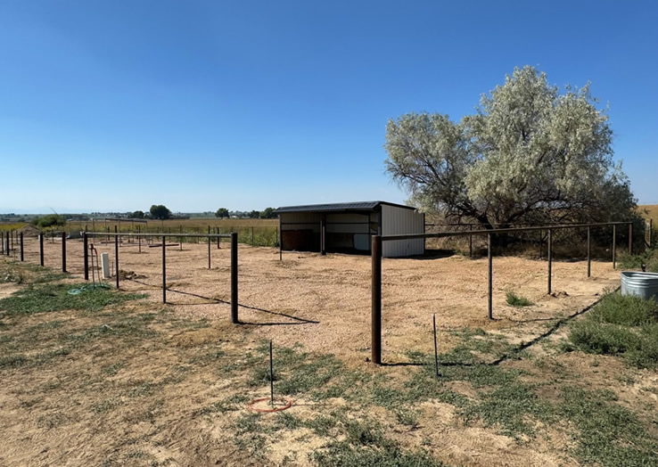Pipe and Cable Fencing, with 3 Strands of Cable with a Rubrail. Shown in stages of Construction, with Posts being set cut to size and the Top Rail Installed. Constructed by Integrity Welding Service LLC, servicing the Front Range of Colorado.