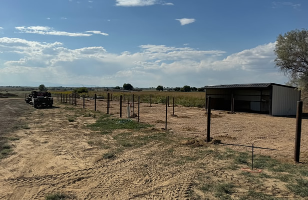 Pipe and Cable Fencing, with 3 Strands of Cable with a Rubrail. Shown in stages of Construction, with Posts being set cut to size and getting ready for the toprail. Constructed by Integrity Welding Service LLC, servicing the Front Range of Colorado.