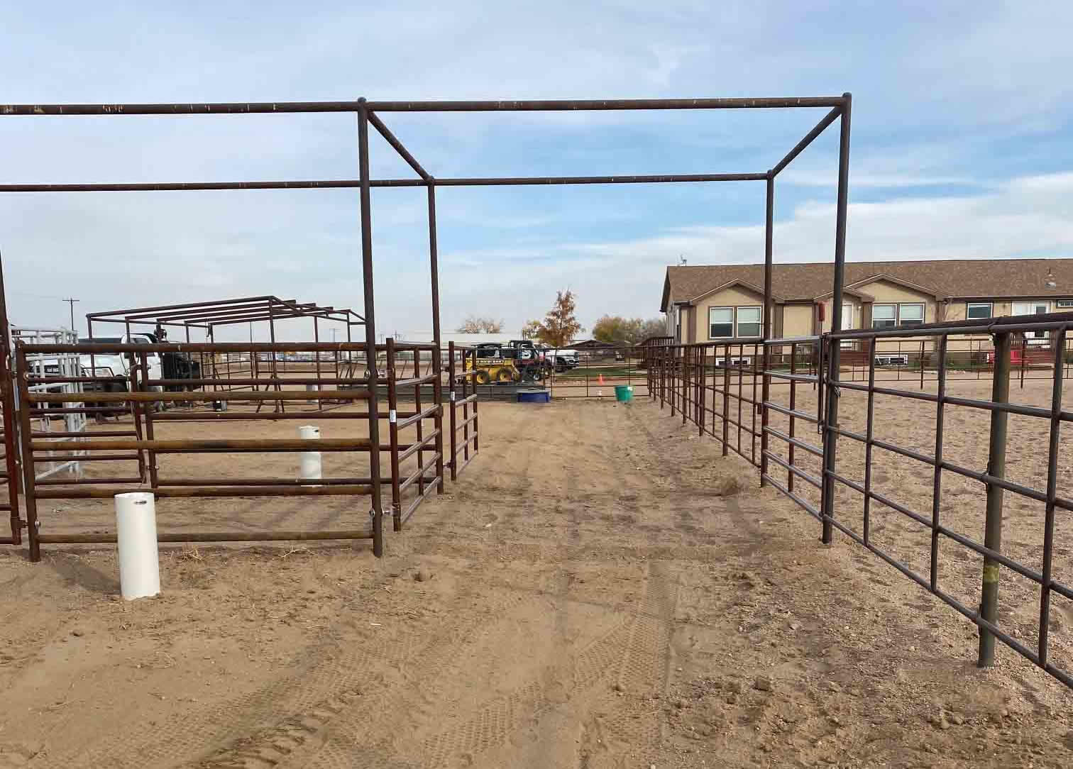 Continous Fence used in an Arena with Attached Cattle Pens. Cattle Working Box Completed, Gates in the alley from the Cow Pens connect to the Round Pen and Arena. Construction by Integrity Welding Service LLC, servicing the Front Range of Colorado.